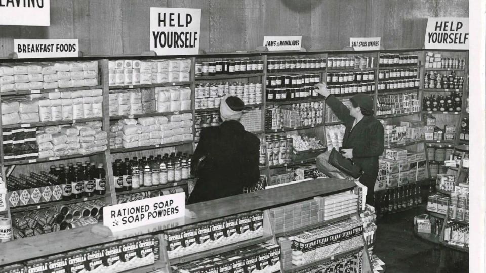 A self-service supermarket, with a sign telling customers to 'Help yourself'